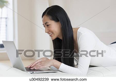 Woman using laptop View Large Photo Image Stock Photo - Woman using laptop. Fotosearch