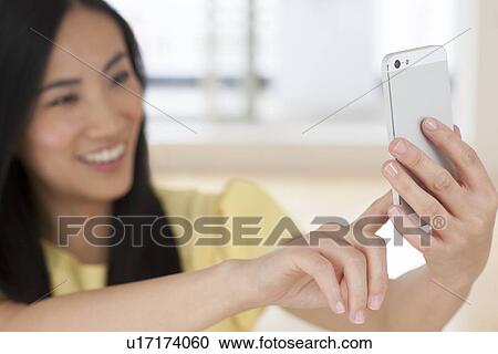 Stock Image - Woman using smartphone. Fotosearch