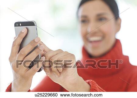 Stock Image - Woman using smartphone. Fotosearch