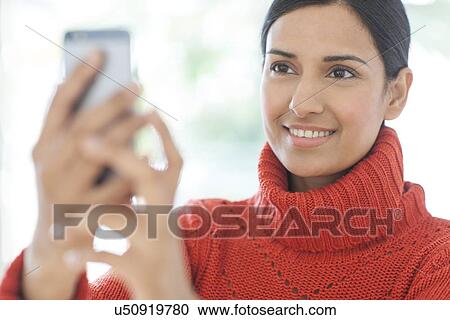 Stock Image - Woman using smartphone. Fotosearch