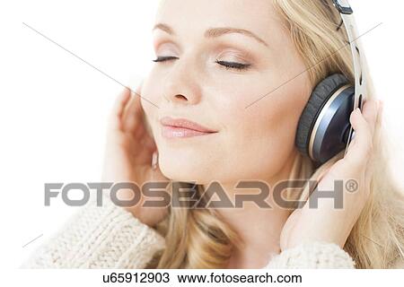 Stock Image - Woman wearing headphones. Fotosearch
