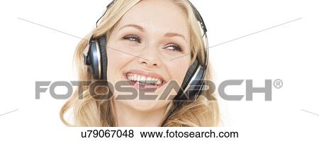 Stock Photo - Woman wearing headphones. Fotosearch