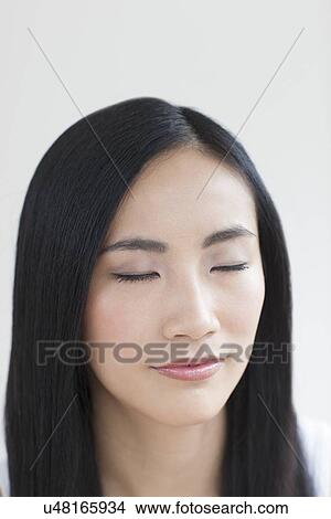 Picture - Woman with eyes closed. Fotosearch