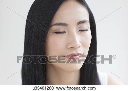 Stock Image - Woman with eyes closed. Fotosearch