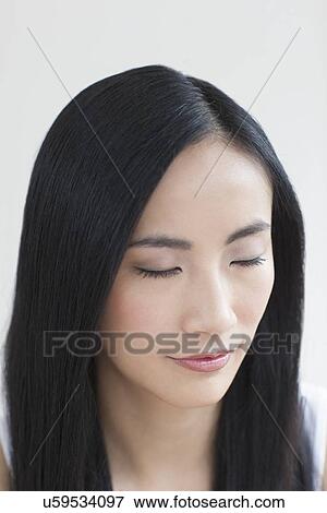 Stock Photo - Woman with eyes closed. Fotosearch