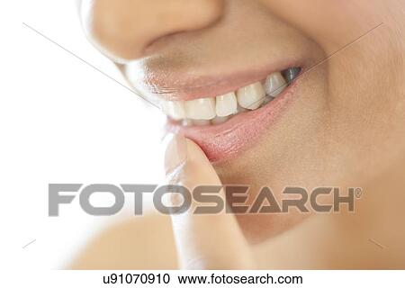 Stock Image - Woman with her finger on her lip. Fotosearch