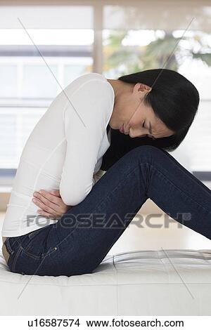 Picture - Woman with stomach ache. Fotosearch
