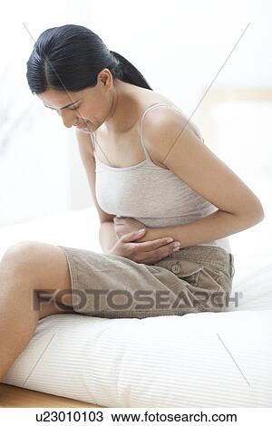 Stock Image - Woman with stomach ache. Fotosearch