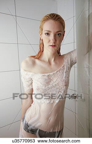 Stock Image - Dressed woman in a shower . Fotosearch