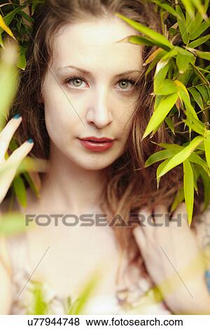 Stock Photo - Woman in plants. Fotosearch
