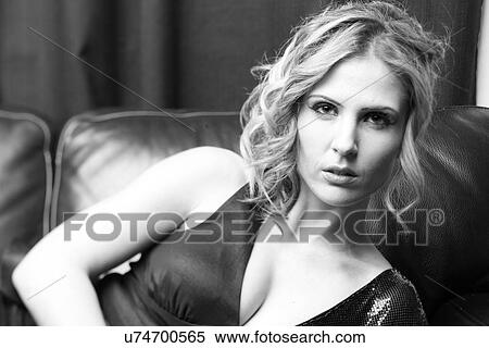 Stock Photography - Woman leaning on a couch . Fotosearch