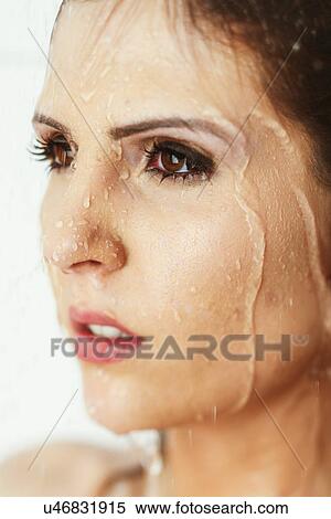 Woman with water running down her face View Large Photo Image Stock Photography - Woman with water running down her face. Fotosearch