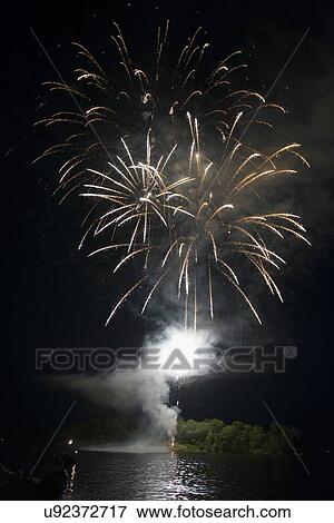 Stock Photo - Canada Day firework display, Keewatin, Unorganized Kenora, Kenora, Lake of The Woods, Ontario, Canada. Fotosearch