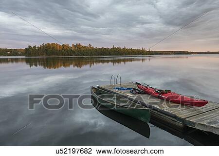 Canoe and Kayak moored at a dock in a lake, Lake of The Woods, Ontario, Canada View Large Photo Image Stock Image - Canoe and Kayak moored at a dock in a lake, Lake of The Woods, Ontario, Canada. Fotosearch