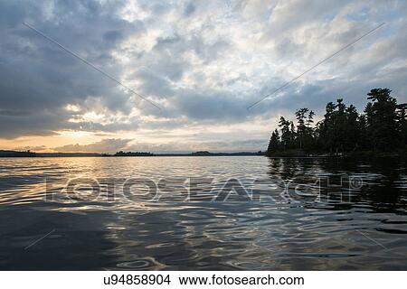 Picture - Clouds over a lake, Lake of The Woods, Ontario, Canada. Fotosearch