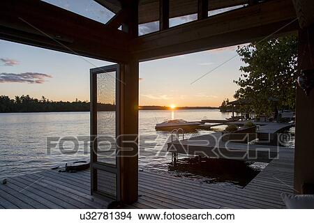 Dock over the lake at sunrise, Lake of The Woods, Ontario, Canada View Large Photo Image Picture - Dock over the lake at sunrise, Lake of The Woods, Ontario, Canada. Fotosearch