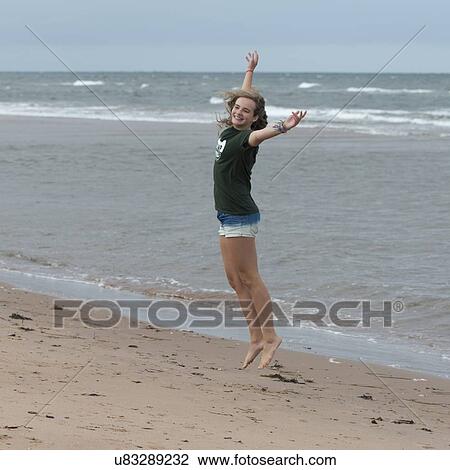 Stock Image - Girl having fun on the beach, York Point, Prince Edward Island, Canada. Fotosearch