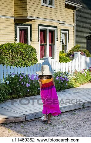 Stock Image - Girl in front of a house, Avonlea, Green Gables, Prince Edward Island, Canada. Fotosearch