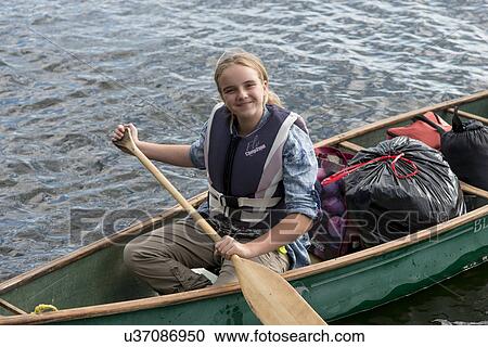 Girl rowing a boat in a lake, Lake of The Woods, Ontario, Canada View Large Photo Image Stock Image - Girl rowing a boat in a lake, Lake of The Woods, Ontario, Canada. Fotosearch