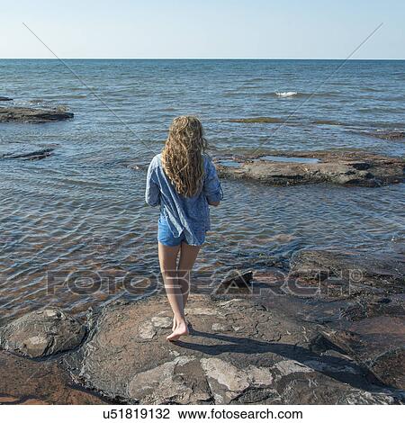 Girl standing on rocks along Cavendish Beach, Green Gables, Prince Edward Island, Canada View Large Photo Image Stock Image - Girl standing on rocks along Cavendish Beach, Green Gables, Prince Edward Island, Canada. Fotosearch