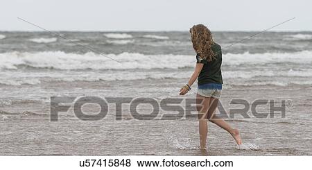 Girl walking on the beach, Prince Edward Island, Canada View Large Photo Image Stock Photo - Girl walking on the beach, Prince Edward Island, Canada. Fotosearch