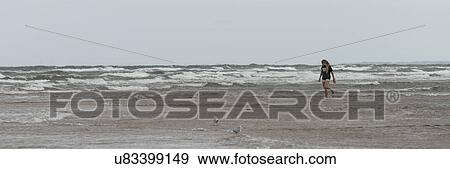 Girl walking on the beach, Prince Edward Island, Canada View Large Photo Image Stock Photo - Girl walking on the beach, Prince Edward Island, Canada. Fotosearch