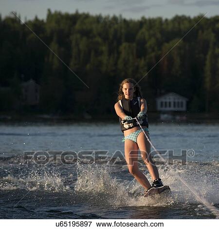 Stock Photo - Girl waterskiing in a lake, Lake of The Woods, Ontario, Canada. Fotosearch