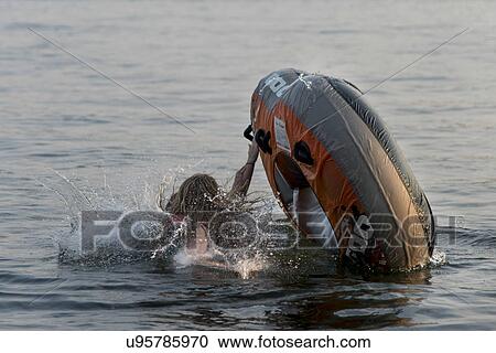 Stock Image - Girl with inflatable raft in a lake, Lake of The Woods, Ontario, Canada. Fotosearch