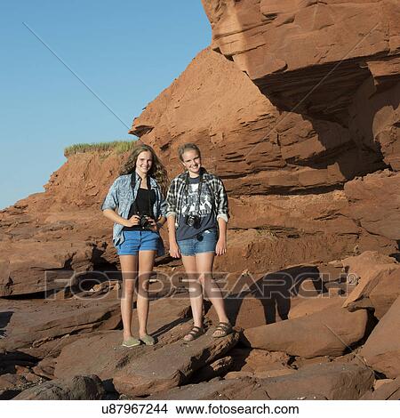 Girls standing on rocky coast, Cavendish Beach, Green Gables, Prince Edward Island, Canada View Large Photo Image Picture - Girls standing on rocky coast, Cavendish Beach, Green Gables, Prince Edward Island, Canada. Fotosearch