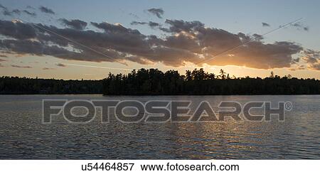 Glow of the sunset at dusk, Lake of The Woods, Ontario, Canada View Large Photo Image Stock Photo - Glow of the sunset at dusk, Lake of The Woods, Ontario, Canada. Fotosearch