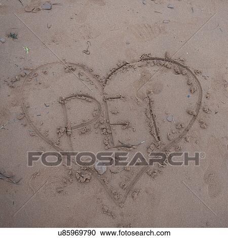 Stock Image - Heart shape drawn on the beach, Victoria Provincial Park, Prince Edward Island, Canada. Fotosearch