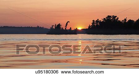 Lake at sunset, Lake of The Woods, Ontario, Canada View Large Photo Image Stock Photograph - Lake at sunset, Lake of The Woods, Ontario, Canada. Fotosearch