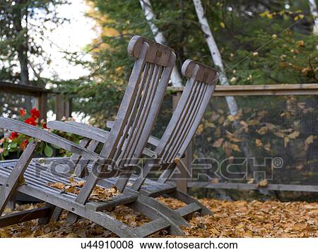 Stock Photo - Lounge Chairs on terrace, Lake of The Woods, Ontario, Canada. Fotosearch