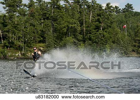 Man waterskiing in a lake, Lake of The Woods, Ontario, Canada View Large Photo Image Stock Image - Man waterskiing in a lake, Lake of The Woods, Ontario, Canada. Fotosearch