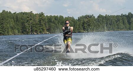 Man waterskiing in a lake, Lake of The Woods, Ontario, Canada View Large Photo Image Stock Image - Man waterskiing in a lake, Lake of The Woods, Ontario, Canada. Fotosearch