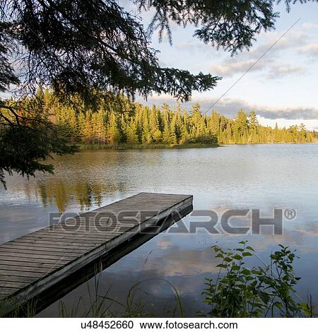 Stock Image - Pier in a lake, Lake of The Woods, Ontario, Canada. Fotosearch
