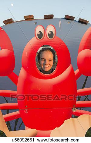 Portrait of a girl smiling through a lobsture sculpture, Spinnakers Landing, Summerside, Prince Edward Island, Canada View Large Photo Image Stock Image - Portrait of a girl smiling through a lobsture sculpture, Spinnakers Landing, Summerside, Prince Edward Island, Canada. Fotosearch