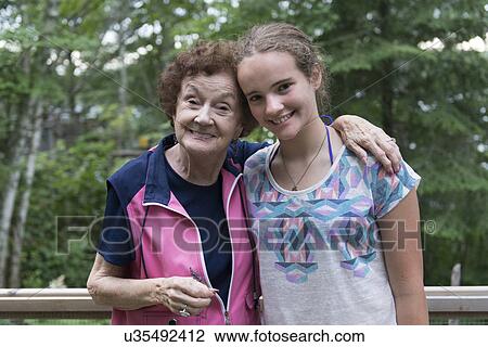 Portrait of a girl with her grandmother smiling, Lake of The Woods, Unorganized Kenora, Kenora, Lake of The Woods, Ontario, Canada View Large Photo Image Stock Image - Portrait of a girl with her grandmother smiling, Lake of The Woods, Unorganized Kenora, Kenora, Lake of The Woods, Ontario, Canada. Fotosearch