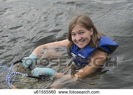 Stock Image - Portrait of a woman prepare to waterski, Lake of The Woods, Ontario, Canada. Fotosearch