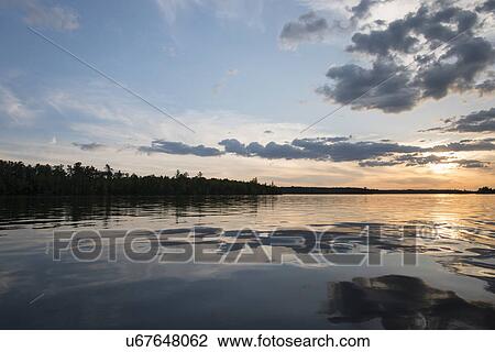 Reflection of clouds at sunset, Lake of The Woods, Ontario, Canada View Large Photo Image Stock Image - Reflection of clouds at sunset, Lake of The Woods, Ontario, Canada. Fotosearch