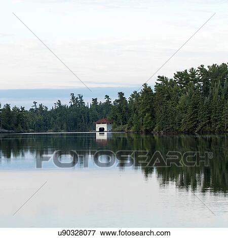 Reflection of trees on water, Lake of The Woods, Ontario, Canada View Large Photo Image Stock Photo - Reflection of trees on water, Lake of The Woods, Ontario, Canada. Fotosearch