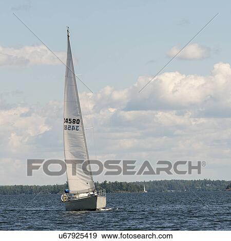Stock Photo - Sailboat in a lake, Lake of The Woods, Ontario, Canada. Fotosearch