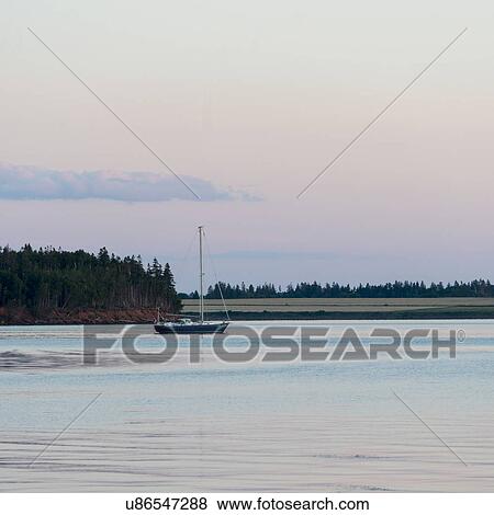 Sailboat in the sea at dusk, Spinnakers Landing, Summerside, Prince Edward Island, Canada View Large Photo Image Stock Photo - Sailboat in the sea at dusk, Spinnakers Landing, Summerside, Prince Edward Island, Canada. Fotosearch