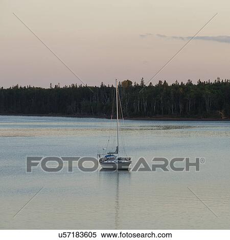 Stock Photography - Sailboat in the sea at dusk, Spinnakers Landing, Summerside, Prince Edward Island, Canada. Fotosearch