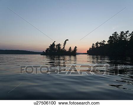 Silhouette of trees at the lakeside, Lake of The Woods, Ontario, Canada View Large Photo Image Stock Image - Silhouette of trees at the lakeside, Lake of The Woods, Ontario, Canada. Fotosearch
