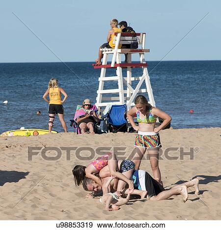 Tourists enjoying on the beach, Cavendish Beach, Green Gables, Prince Edward Island, Canada View Large Photo Image Stock Photo - Tourists enjoying on the beach, Cavendish Beach, Green Gables, Prince Edward Island, Canada. Fotosearch
