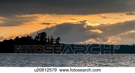 Trees at the lakeside at dusk, Lake of The Woods, Ontario, Canada View Large Photo Image Stock Photo - Trees at the lakeside at dusk, Lake of The Woods, Ontario, Canada. Fotosearch