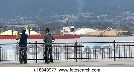 Two cyclists viewing Burrard Inlet, Vancouver, British Columbia, Canada View Large Photo Image Stock Photo - Two cyclists viewing Burrard Inlet, Vancouver, British Columbia, Canada. Fotosearch