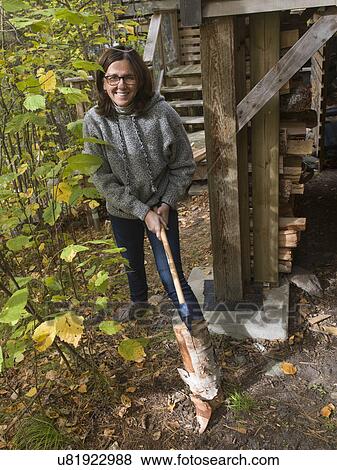 Woman chopping firewood with axe, Lake of The Woods, Ontario, Canada View Large Photo Image Stock Photo - Woman chopping firewood with axe, Lake of The Woods, Ontario, Canada. Fotosearch