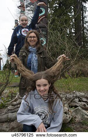 Stock Photography - Woman with her daughters having fun at Stanley Park, Vancouver, British Columbia, Canada. Fotosearch